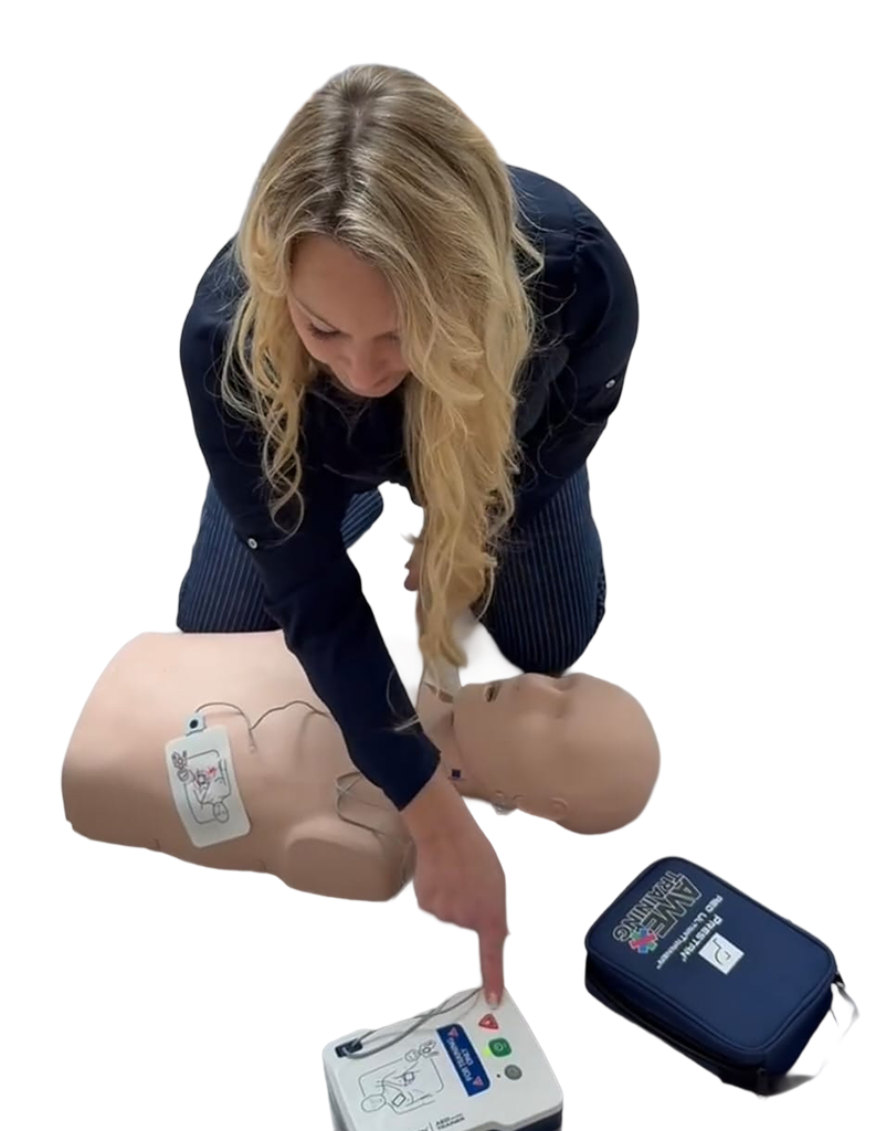 AWE Training instructor demonstrating CPR and AED use on a training manikin