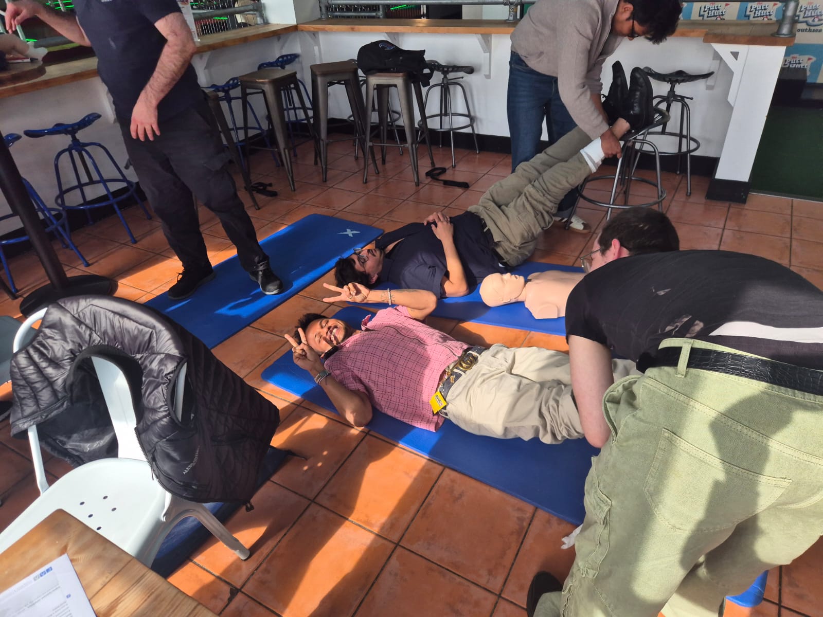 Learners practising first aid skills during a hands-on training session